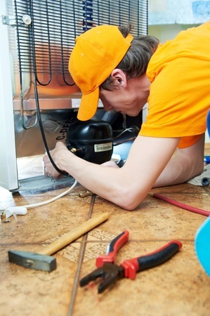 repairman fixing the fridge